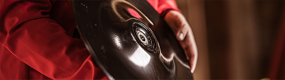 Close-up of someone holding a Väderstad seed drill disc in their hand