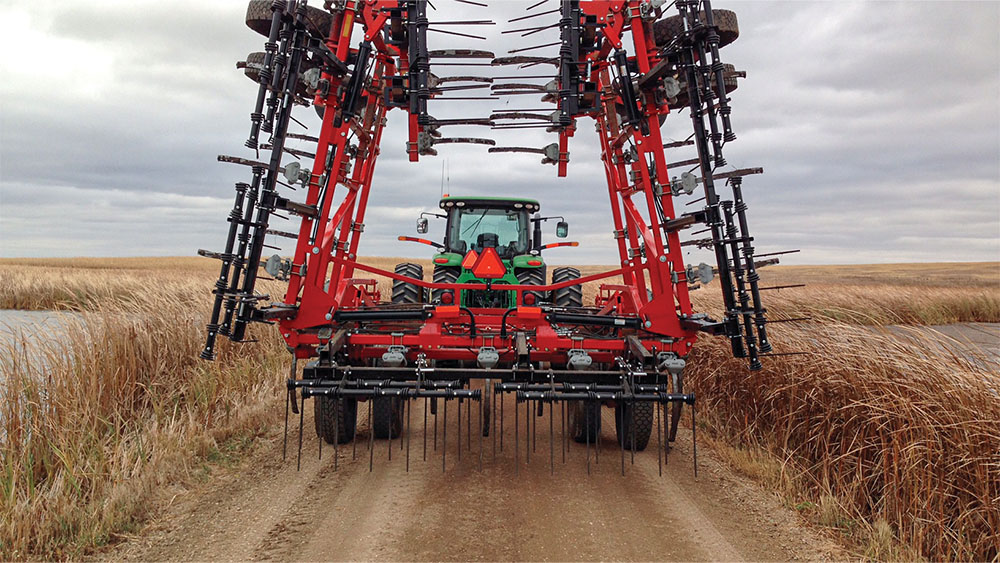Wil-Rich 2500 Series Chisel Plow with wings folded, on a road