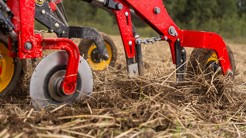 Close-up on front disc, tine coulters and press wheel on a Seed Hawk 900C seed drill.