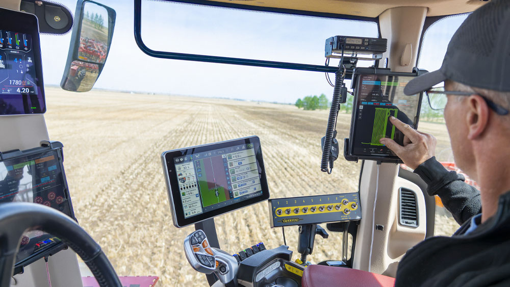 Farmer using Väderstad iCon Wireless Control System in a tractor