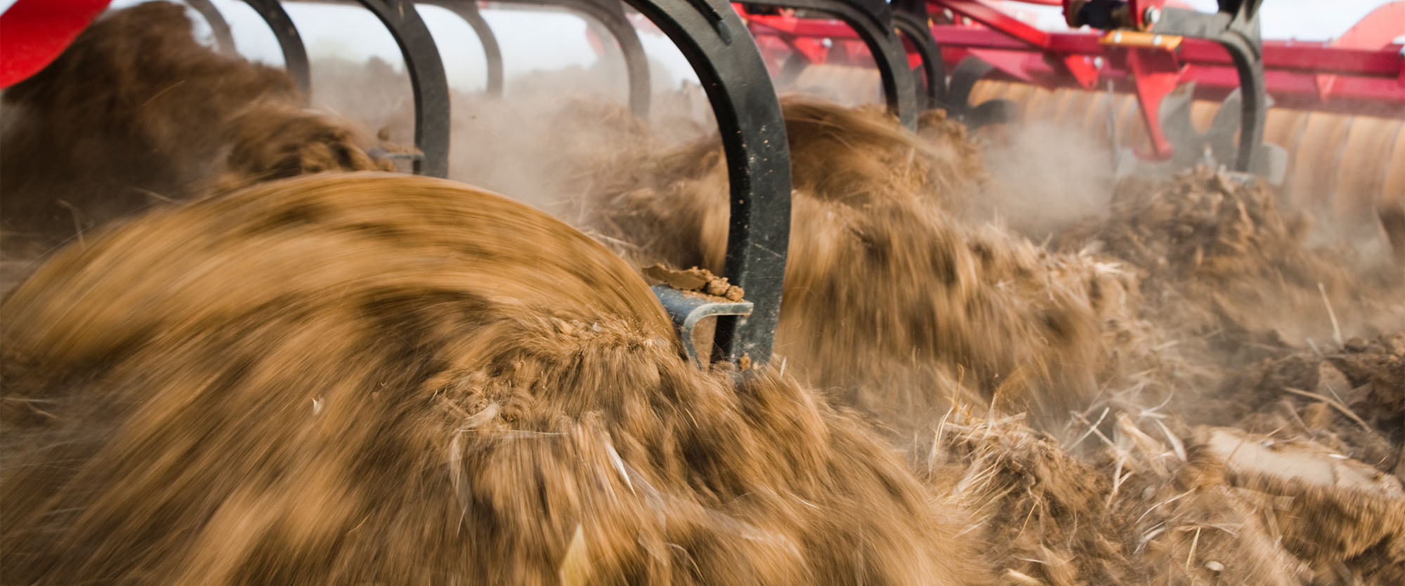 Closeup of Väderstad MixIn shins working the soil in a field