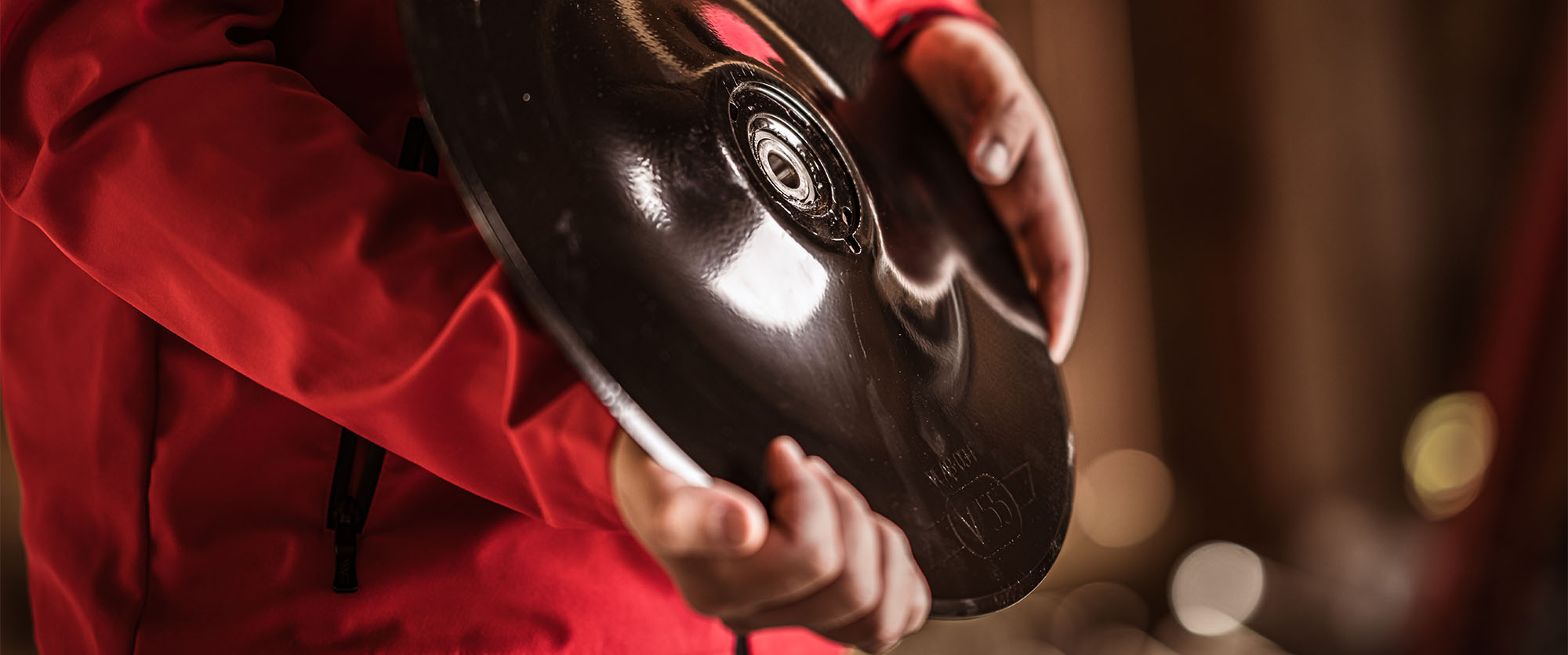Close-up of someone holding a Väderstad seed drill disc in their hands.