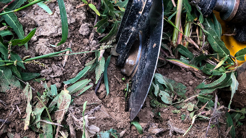 Close-up showing how the Seed Hawk 900C front disc cuts residue in the field.