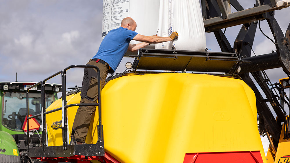 A man filling seeds into the Seed Hawk 900C hopper.