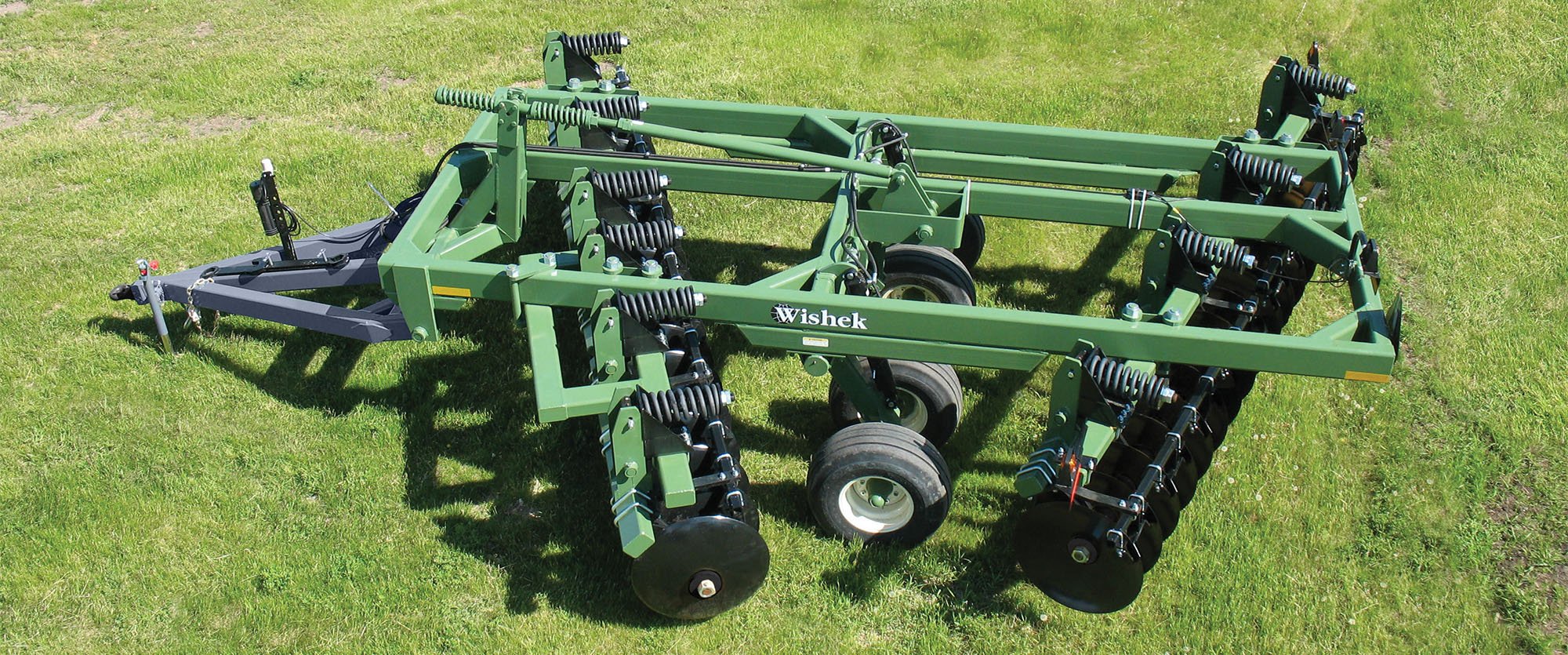 Wishek 842N Offset Disc cultivator on a green field